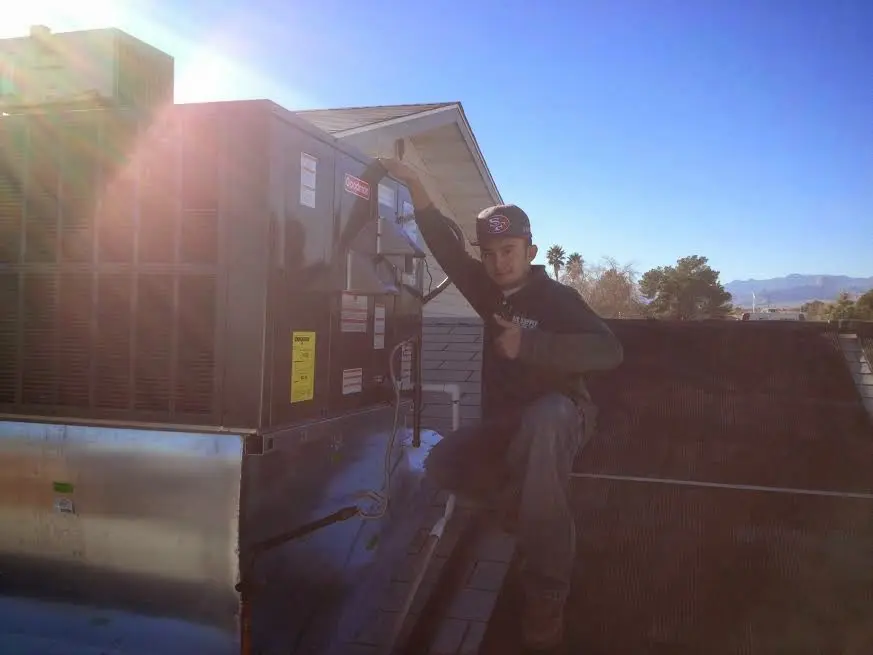 HVAC technician performing HVAC Inspection on a rooftop unit in Portland